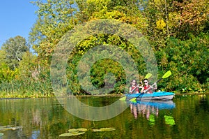 Family kayaking, mother and child paddling in kayak on river canoe tour, active summer weekend and vacation