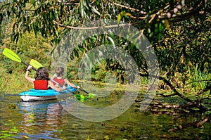 Family kayaking, mother and child paddling in kayak on river canoe tour, active summer weekend and vacation, sport and fitness