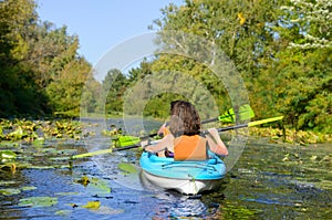 Family kayaking, mother and child paddling in kayak on river canoe tour having fun, active weekend and vacation, fitness co