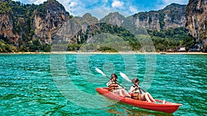 Family kayaking, mother and daughter paddling in kayak on tropical sea canoe tour near islands, having fun, vacation in Thailand