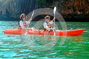 Family kayaking, mother and daughter paddling in kayak on tropical sea canoe tour near islands, having fun, active vacation