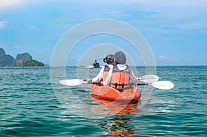 Family kayaking, mother and daughter paddling in kayak on tropical sea canoe tour near islands, having fun, active vacation