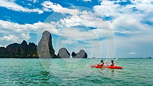 Family kayaking, mother and daughter paddling in kayak on tropical sea canoe tour near islands, having fun, Thailand, Krabi