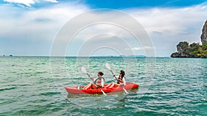 Family kayaking, mother and daughter paddling in kayak on tropical sea canoe tour near islands, having fun, Thailand, Krabi