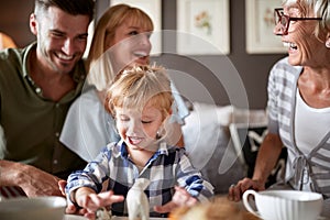 Family with kid having fun in visit to grandmother