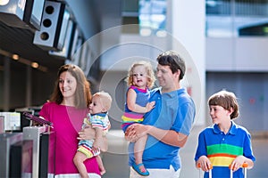 Family with kids at airport