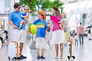 Family with kids at airport