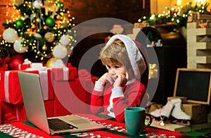 Family with kids celebrating Christmas at home. New Year surprise present. Joy and happiness. Boy child with laptop near