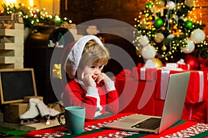 Family with kids celebrating Christmas at home. New Year surprise present. Joy and happiness. Boy child with laptop near