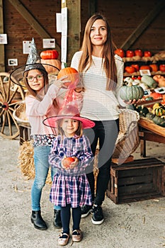 Family with kids choosing halloween pumpkin