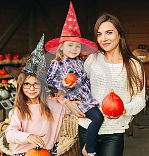 Family with kids choosing halloween pumpkin