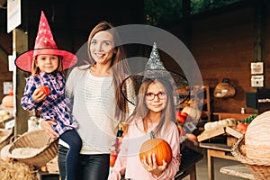 Family with kids choosing halloween pumpkin