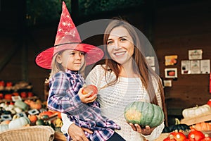 Family with kids choosing halloween pumpkin