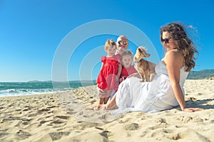 Family with kids and dog on the beach