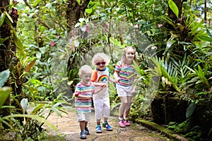 Family with kids hiking in jungle.