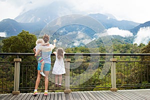 Family with kids looking at mountain.