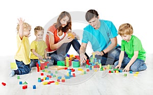 family with kids playing toys blocks