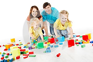family with kids playing toys blocks