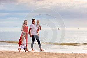 Family with kids on tropical beach. Sea vacation