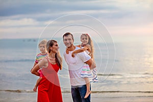 Family with kids on tropical beach. Sea vacation