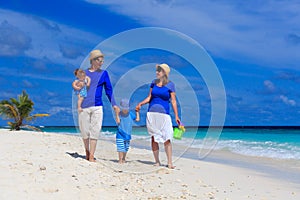 Family with kids walking on tropical beach