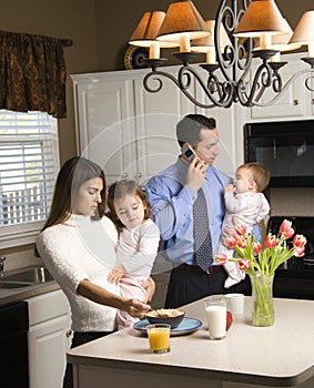 Family in kitchen.