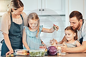 Family in kitchen, cooking together with children and teaching, learning and nutrition with parents. Mom, dad and girl