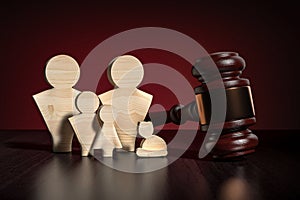 Family law civilian concept - wooden people family figures and wooden gavel on table