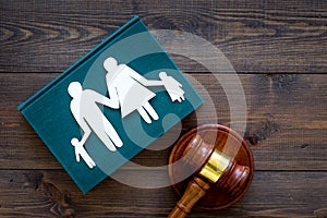 Family law, family right concept. Child-custody concept. Family with children cutout near court gavel on dark wooden