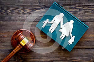 Family law, family right concept. Child-custody concept. Family with children cutout near court gavel on dark wooden