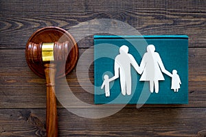 Family law, family right concept. Child-custody concept. Family with children cutout near court gavel on dark wooden