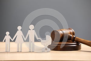 Family law. Figure of parents with children and gavel on wooden table