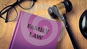 Family law and gavel on a table. With glasses background.