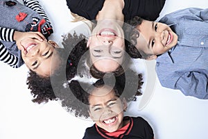 A family lay on the floor of a photography studio