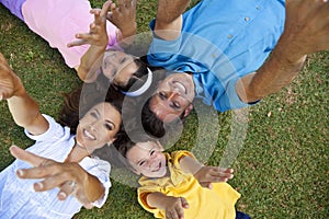 Family Laying Down Hands Up Laughing