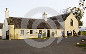 A family leaving the small tea shop in Castlewellan Country Park during a mid term school break.