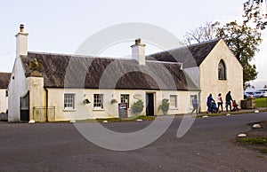 A family leaving the small tea shop in Castlewellan Country Park during a mid term school break.