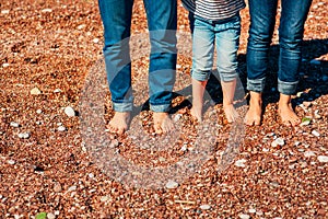 Family legs on the beach. Parents with children on the beach. Fa