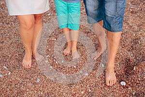 Family legs on the beach. Parents with children on the beach. Fa