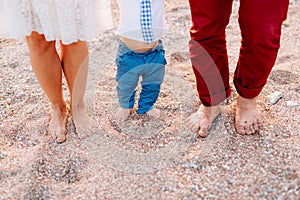 Family legs on the beach. Parents with children on the beach. Fa