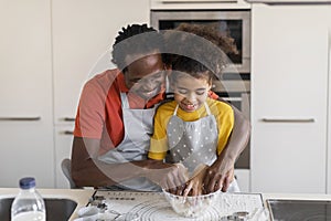 Family Leisure. Black Father And Daughter Kneading Dough While Baking At Home