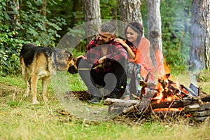 Family leisure concept. Couple play with german shepherd dog