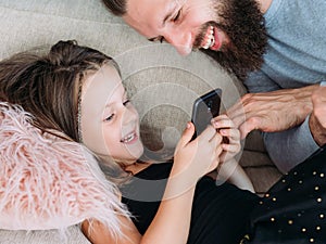 Family leisure girl dad watch phone joy laughter