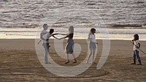 Family, leisure and people concept- big asian happy family communication and drawing heart on tropical beach