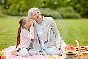 Grandmother and granddaughter at picnic in park