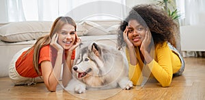 family LGBT diversity lesbian couple with dog in room. LGBT lifestyle