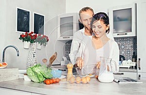 Family lifestyle scene - cooking process, marrieds makes breakfast together