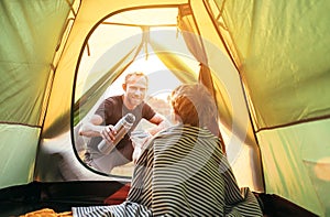 Family lisure concept image. Father and son prepare for camping in mountain, drink tea in ten