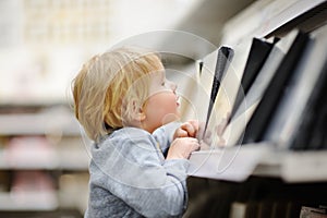 Family with little boy choosing the right furniture for their apartment in a modern home furniture store