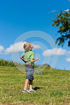 Family - little boy playing badminton outdoors